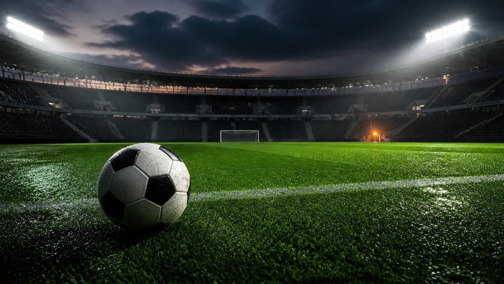Voetbal op een nat veld onder stadionverlichting